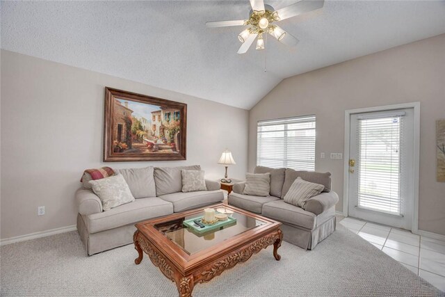 8006 Etienne Dr, Corpus Christi, TX 78414 - living room with a ceiling fan, baseboards, vaulted ceiling, light tile patterned floors, and a textured ceiling