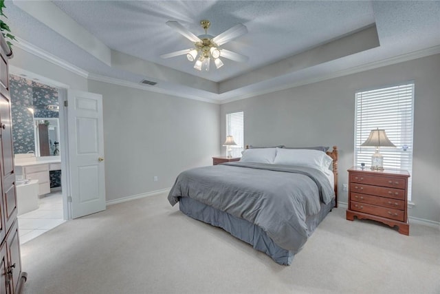8006 Etienne Dr, Corpus Christi, TX 78414 - bedroom featuring a raised ceiling, light carpet, baseboards, crown molding, and ensuite bath