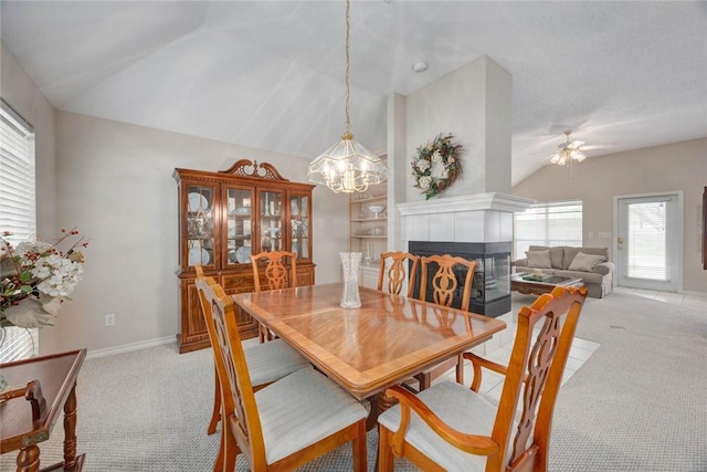 8006 Etienne Dr, Corpus Christi, TX 78414 - dining room with vaulted ceiling, light carpet, a ceiling fan, a tile fireplace, and a chandelier