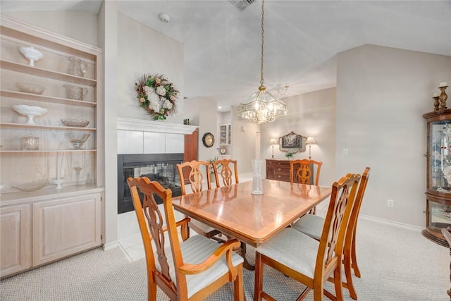 8006 Etienne Dr, Corpus Christi, TX 78414 - dining area featuring vaulted ceiling, light carpet, a tile fireplace, a chandelier, and baseboards