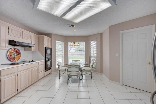 8006 Etienne Dr, Corpus Christi, TX 78414 - kitchen featuring under cabinet range hood, black appliances, a chandelier, light countertops, and a textured ceiling