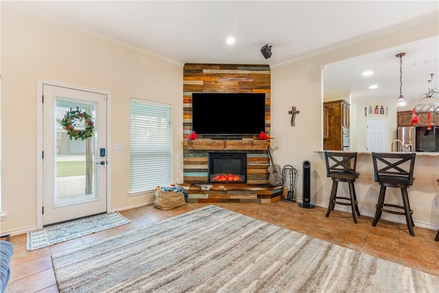 living room with ornamental molding, light tile patterned flooring, a stone fireplace, and baseboards