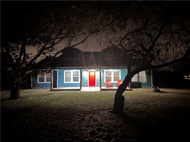 view of back of house at night