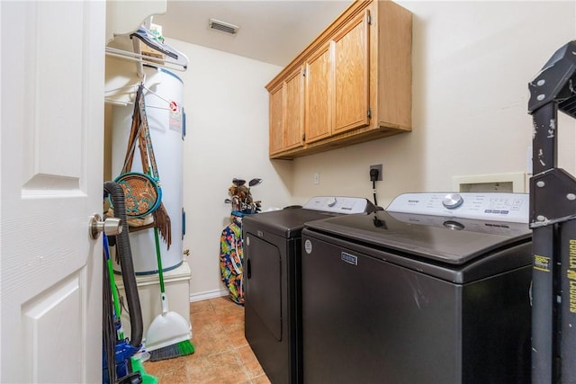 washroom featuring cabinet space, light tile patterned floors, baseboards, visible vents, and separate washer and dryer