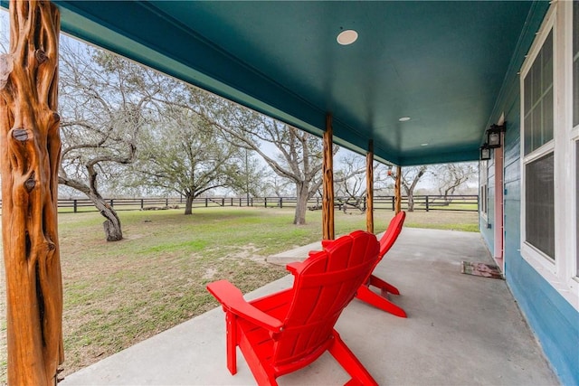 view of patio with a rural view and fence