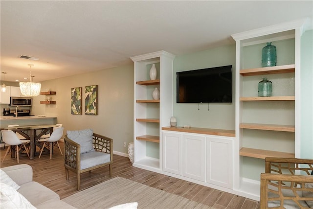 living area with light wood-style floors and baseboards