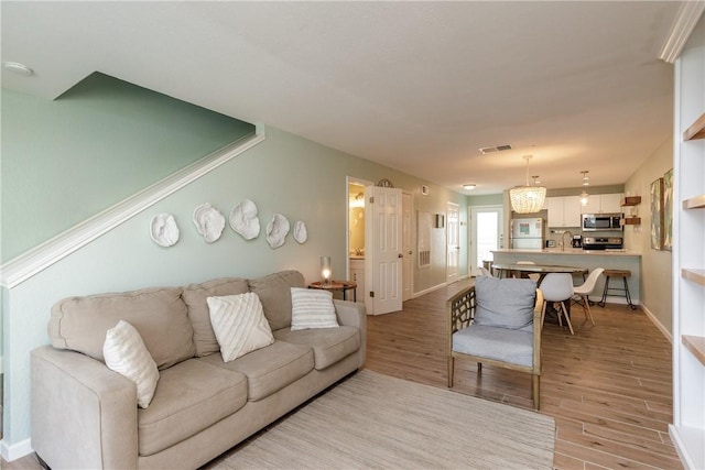living room featuring wood finished floors and baseboards