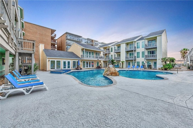 view of pool with a patio area and a pool with connected hot tub