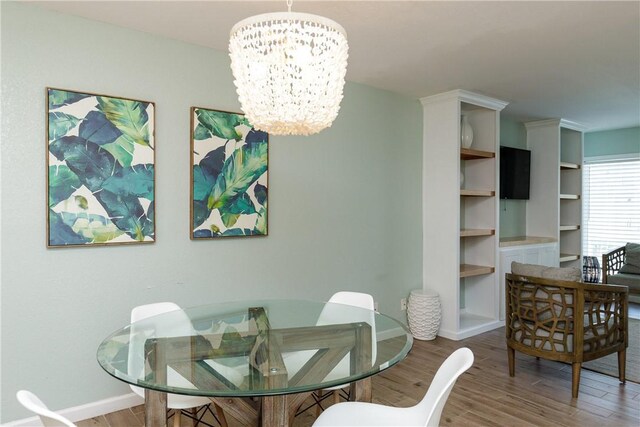 14802 Windward Dr Unit 233, Corpus Christi, TX 78418 - dining area featuring a chandelier, wood finished floors, and baseboards