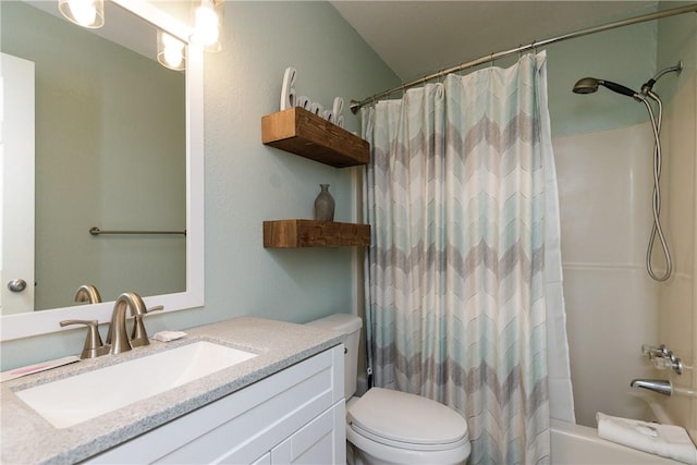 bathroom featuring toilet, shower / bath combo with shower curtain, and vanity