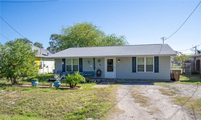 single story home with a porch and a front yard