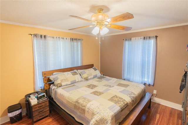 bedroom featuring ceiling fan, dark hardwood / wood-style floors, and ornamental molding