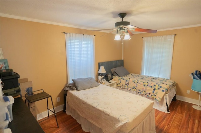 bedroom with ceiling fan, crown molding, and dark hardwood / wood-style floors