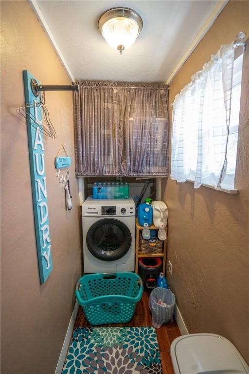 laundry area with washer / dryer and wood-type flooring