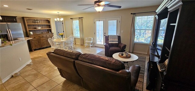 tiled dining space with plenty of natural light, ceiling fan, sink, and french doors