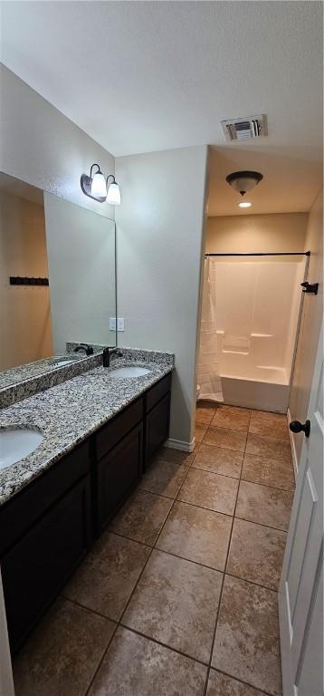 bathroom with tile patterned floors, shower / bath combo, and toilet