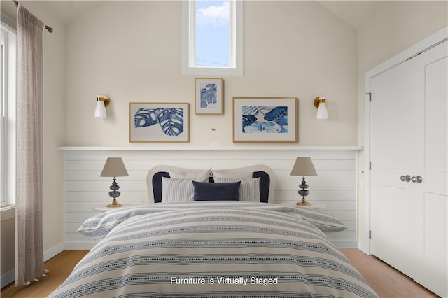 bedroom featuring vaulted ceiling and light hardwood / wood-style flooring