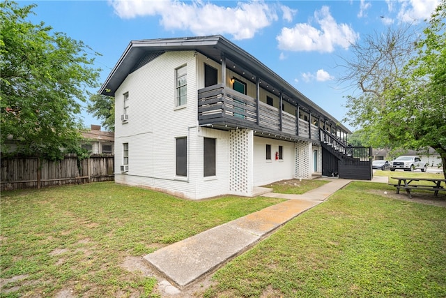 view of home's exterior featuring a lawn and a wooden deck