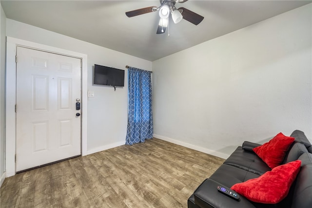 living area with hardwood / wood-style flooring and ceiling fan