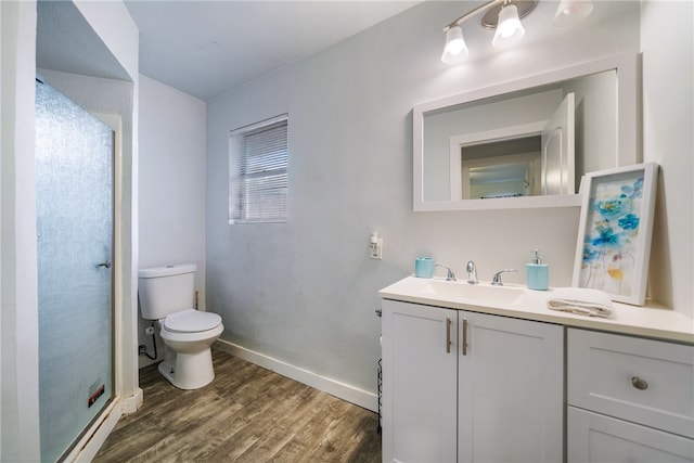 bathroom featuring wood-type flooring, vanity, and toilet