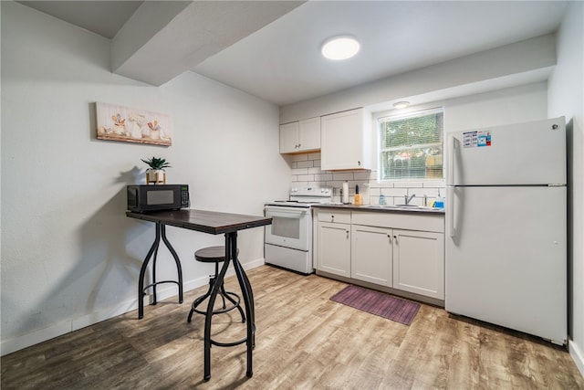 kitchen with white cabinets, sink, tasteful backsplash, light wood-type flooring, and white appliances