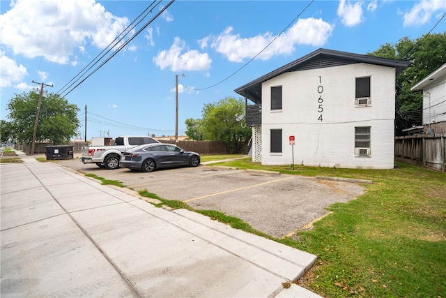 view of parking featuring a yard