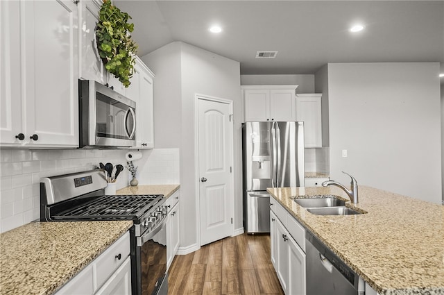 2689 Everly Ln, Corpus Christi, TX 78415 - kitchen featuring stainless steel appliances, a sink, dark wood-style flooring, white cabinets, and recessed lighting