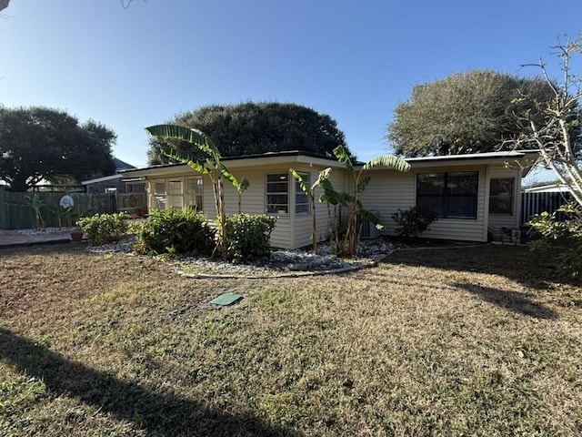 back of property featuring a lawn