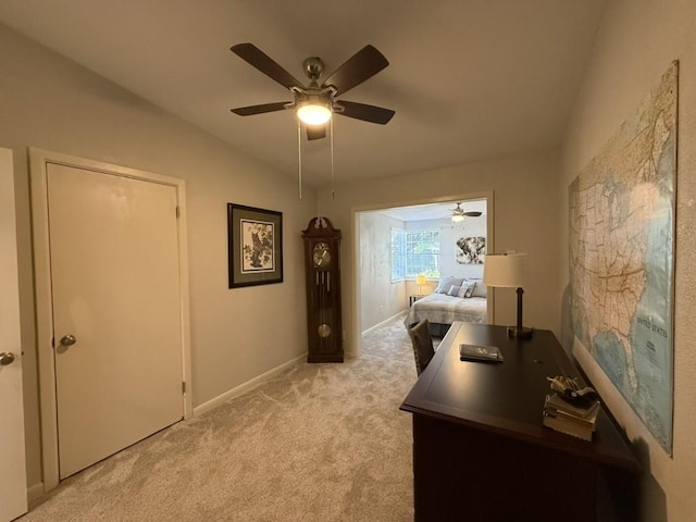 carpeted office featuring ceiling fan and vaulted ceiling