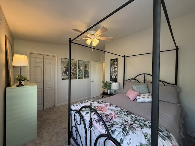 carpeted bedroom featuring ceiling fan and a closet