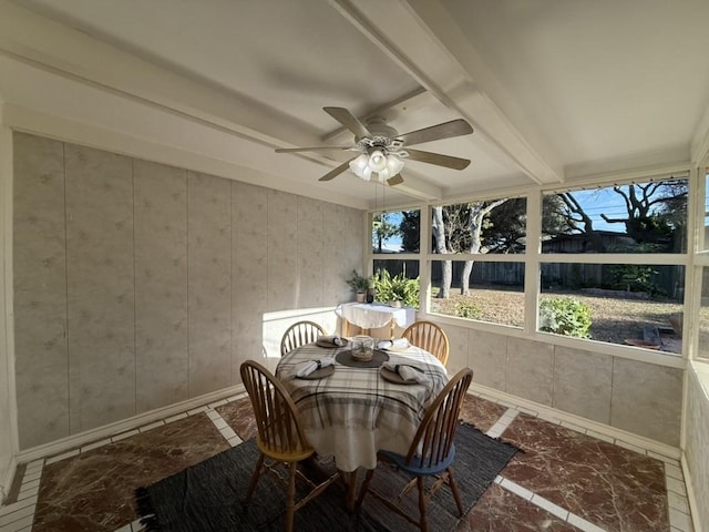 sunroom / solarium with ceiling fan and beamed ceiling