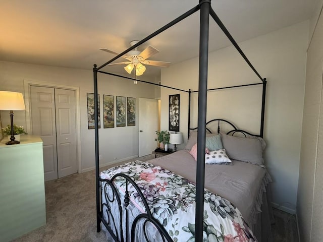 carpeted bedroom featuring ceiling fan and a closet