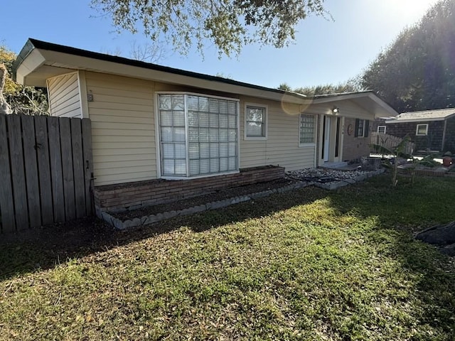 rear view of property with a lawn