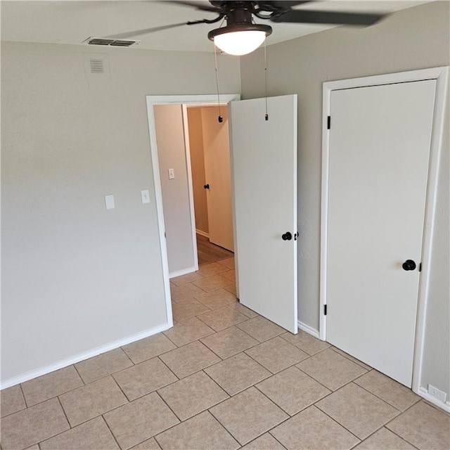 4749 Mokry Dr, Corpus Christi, TX 78415 - unfurnished bedroom featuring light tile patterned floors and a ceiling fan