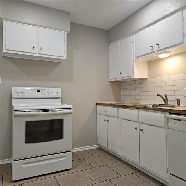 4749 Mokry Dr, Corpus Christi, TX 78415 - kitchen with white appliances, baseboards, decorative backsplash, white cabinetry, and a sink