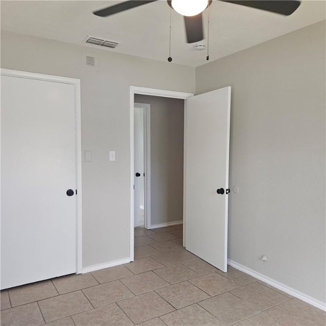 4749 Mokry Dr, Corpus Christi, TX 78415 - unfurnished bedroom featuring light tile patterned floors, baseboards, and a ceiling fan