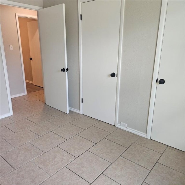 4749 Mokry Dr, Corpus Christi, TX 78415 - unfurnished bedroom featuring light tile patterned floors and a closet