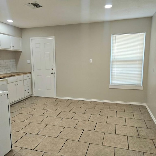 4749 Mokry Dr, Corpus Christi, TX 78415 - kitchen with recessed lighting, white cabinetry, decorative backsplash, light countertops, and range