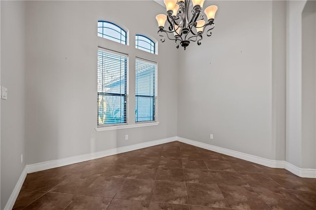 unfurnished room with an inviting chandelier