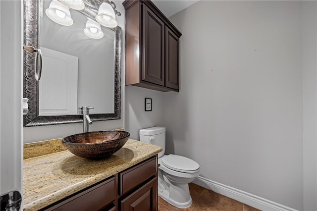 bathroom featuring tile patterned flooring, vanity, and toilet