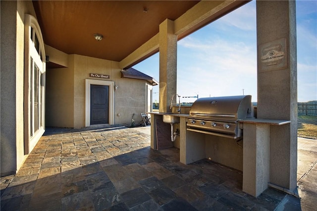 view of patio with exterior kitchen, grilling area, and sink