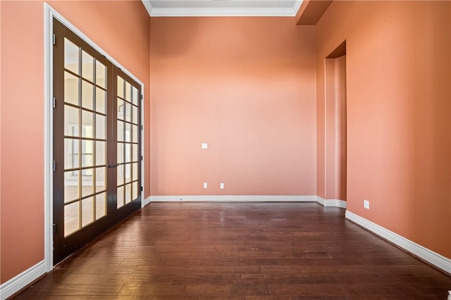 spare room featuring ornamental molding, french doors, and dark hardwood / wood-style floors