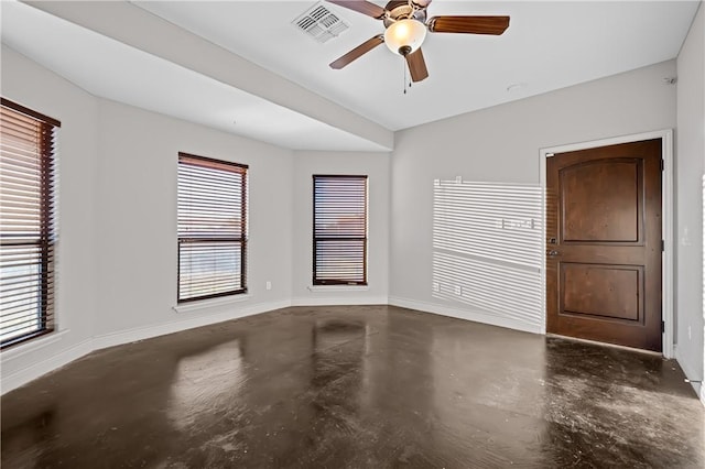 unfurnished room with ceiling fan and a wealth of natural light