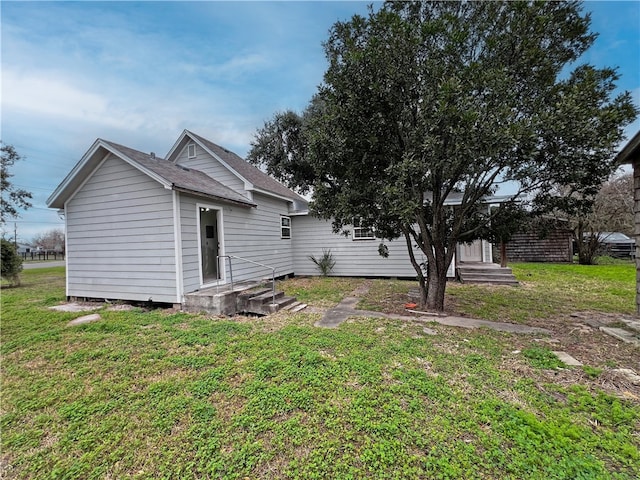 back of property with a lawn