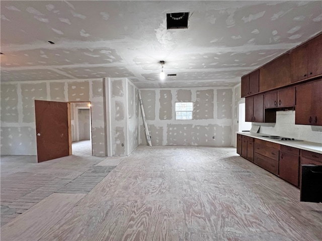 kitchen with dark brown cabinets and white stovetop