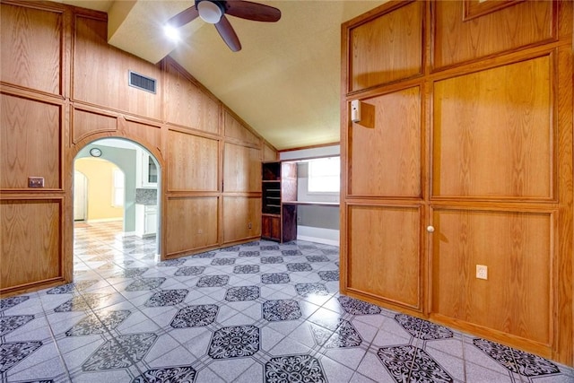 kitchen featuring ceiling fan and lofted ceiling