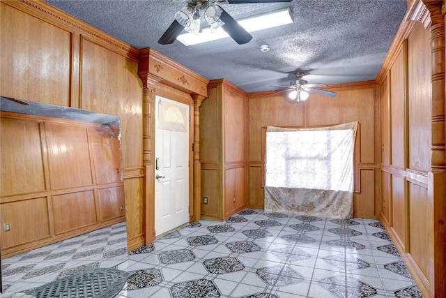 interior space with wooden walls, a closet, and ceiling fan