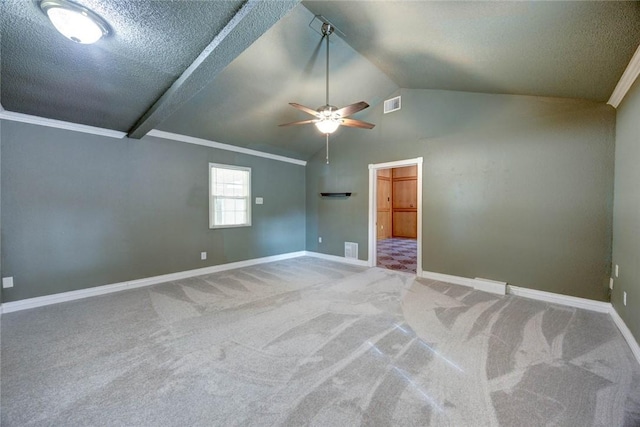 empty room with carpet floors, a textured ceiling, lofted ceiling, and ceiling fan