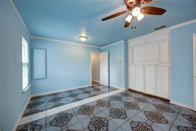 unfurnished bedroom with crown molding, light tile patterned flooring, a closet, and ceiling fan