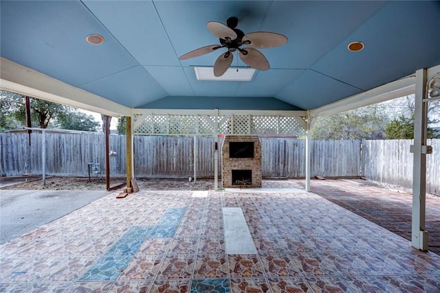 view of patio / terrace featuring ceiling fan and exterior fireplace